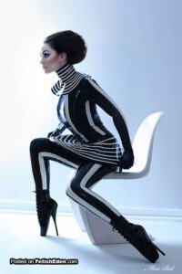 lady-in-black-latex-mini-dress-and-black-latex-leggings-with-black-latex-gloves–short-black-ballet-boots-and-high-collar.jpg