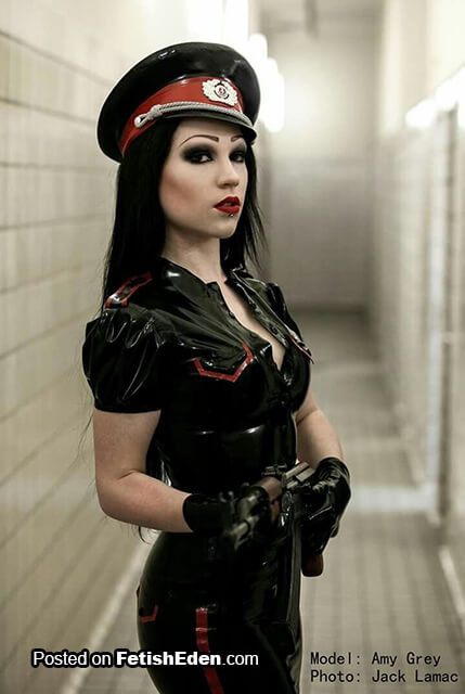 Brunette Amy Grey in black latex military uniform and black latex gloves Black latex military uniform on sexy brunette Amy Grey