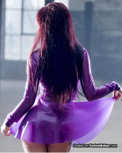 Woman lifting her transparent purple latex mini-dress