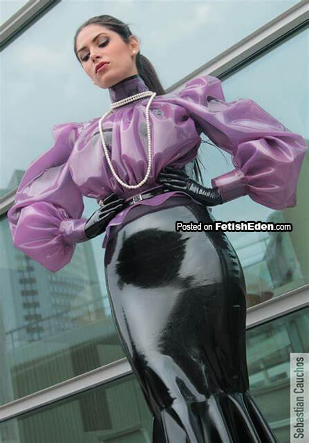 Transparent lilac latex blouse on brunette in long black latex skirt with short black latex gloves Brunette in lilac latex blouse and black latex skirt