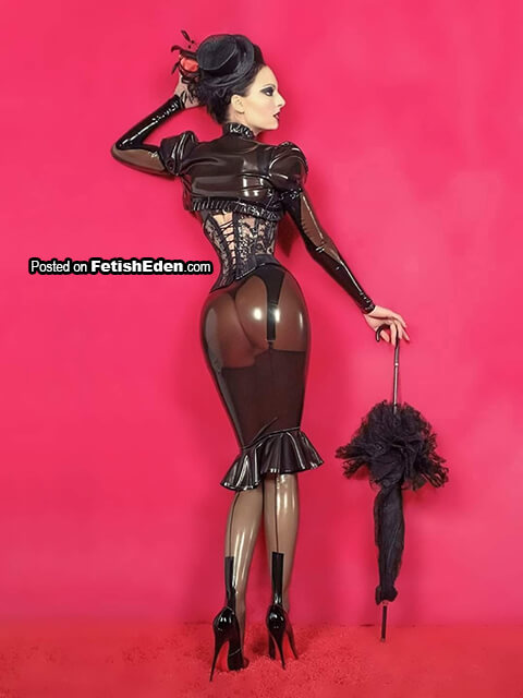 Brunette lady with a parasol wearing smoky latex outfit