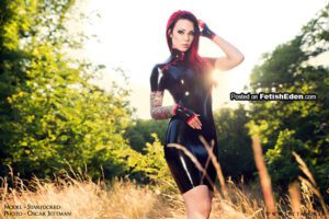 Starfucked tattooed redhead in black latex mini-dress