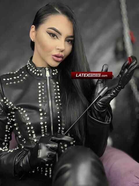 Leather Domme holds Her riding crop