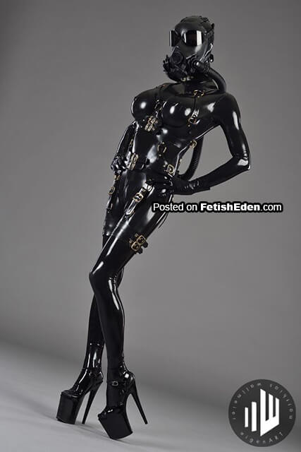 The mystery descends in black latex catsuit with gas mask and the world forgets how to breathe