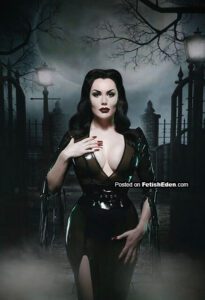Morrigan Hel wearing a translucent olive latex dress in a gothic cemetery-like setting with mist, lamp posts, and iron gates.